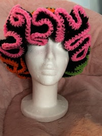 a mannequin wearing a crocheted hat